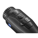 Close-up of a black Zeiss optical device, likely a monocular or laser sight, showing the eyepiece, textured grip, and control buttons on a white background.